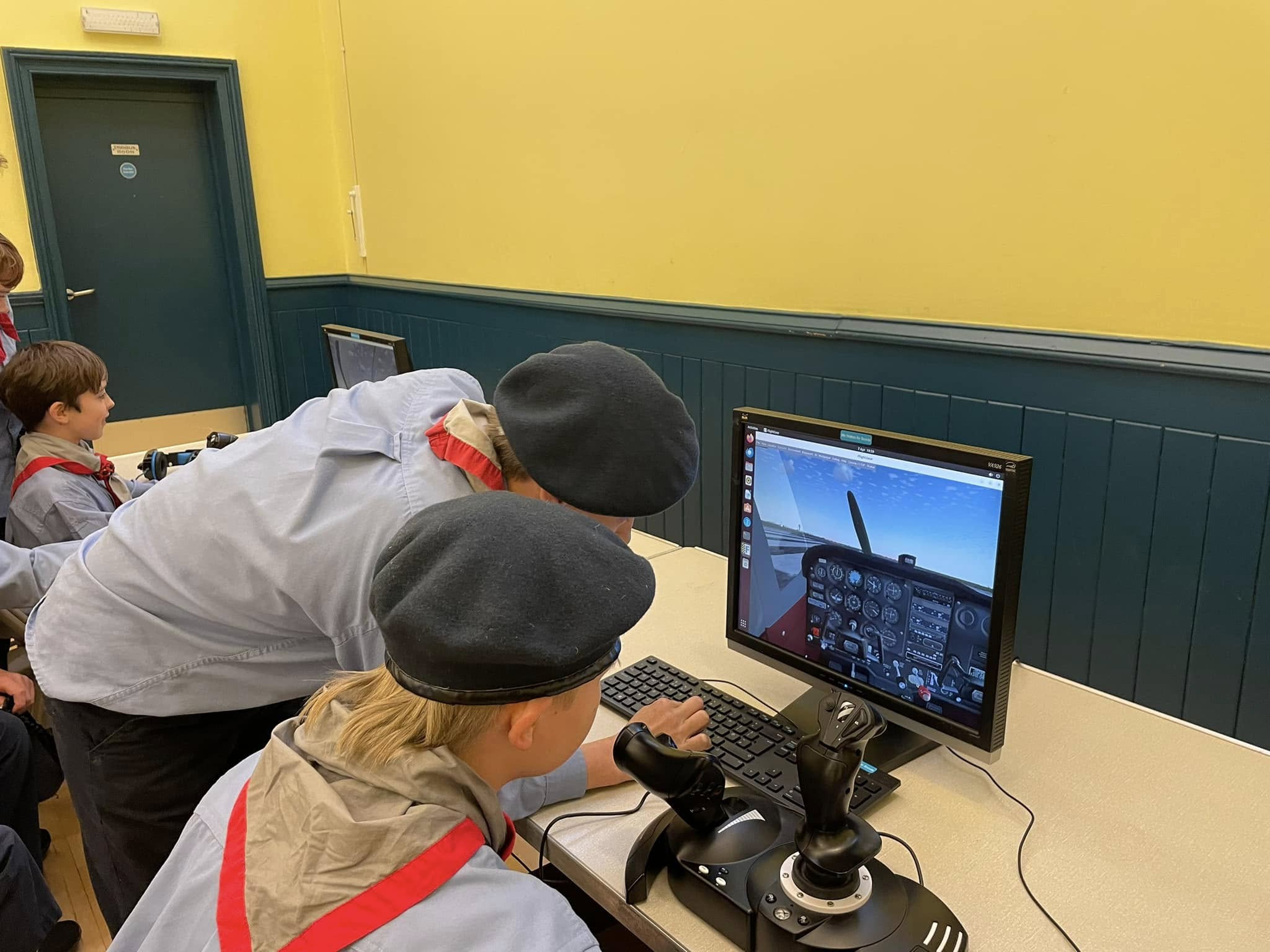 Two scouts use a flight simulator